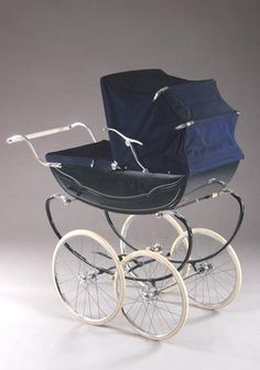 an old fashioned baby carriage with wheels and blue fabric in the front, on a gray background