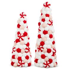 two red and white christmas trees made out of pom - poms are shown