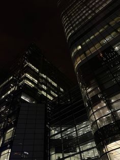 some very tall buildings at night time