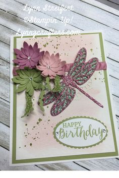 a handmade birthday card with flowers and a dragonfly on the front, says happy birthday