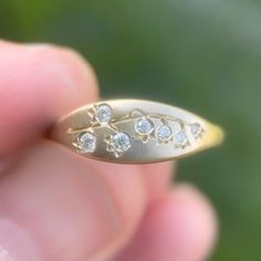 Lily of the valley ring in 14k gold with moissanite. I hand engrave deep lines for the stem and set the stones in a way that resembles petals. A satin finish emphasizes the details. Measures 6 mm at top and the band tapers in back to 2 mm. Moissanites range from 1.7 to 1 mm. It's a delicate but still recognizable design. The one shown is a size 4 (pinky ring size) so if you're wearing it on a larger finger it'll show more of the band to each side. Deep Lines, Signet Rings, Jewelry Lookbook, Pinky Ring, Jewelry Inspo, Dream Jewelry, Lily Of The Valley, Lab Diamonds, Signet Ring