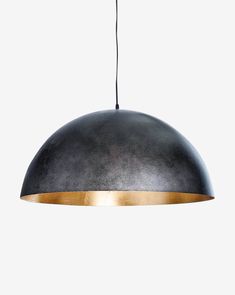 a black and gold pendant light hanging from a ceiling