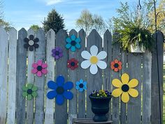 a wooden fence with flowers painted on it