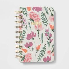 a notebook with flowers and the word mom written in gold foil on top of it