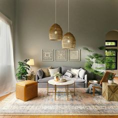 a living room filled with lots of furniture next to a wall mounted plant on top of a hard wood floor