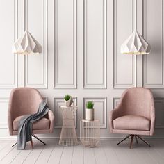 two chairs and a table in an empty room with white paneling on the walls