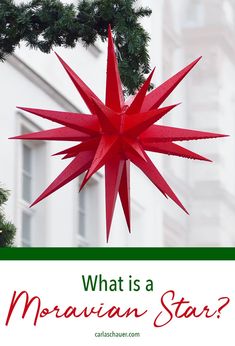 a red star hanging from the side of a christmas tree with text overlay that reads, what is a moravian star?