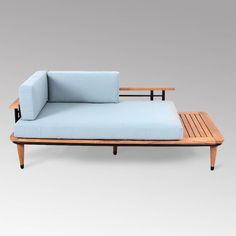 a blue couch sitting on top of a wooden table