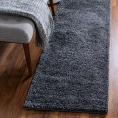 a gray rug on the floor in a living room