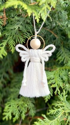 an angel ornament hanging from a tree