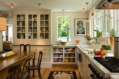 a kitchen filled with lots of counter top space next to a dining room table and chairs