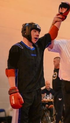 two men wearing boxing gloves and holding up their hands