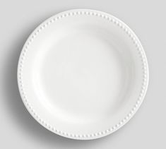 an empty white plate on a gray background