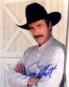 an autographed photo of a man in a cowboy hat with his arms crossed