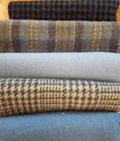 four different plaid fabrics stacked on top of each other