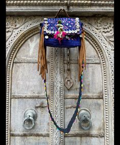 About bag  Indo-gypsy fusion, everyday use hand bag made from Banjara fabrics sourced from Vintage tribal costumes of regions of Rajastan and Gujarat. These are embellished with light catching coins, and intricate bead work tassels. Size - length 15 inches/ width 21 inches Company details:  Company name: Houseoftextile  Contact number: +919784447473  Email id: houseoftextile77@gmail.com  Shipping & custom : Delivery through one of the finest service providers : Skyway, Fedex, UPS  And DHL. Any l Handmade Blue Shoulder Bag For Festivals, Traditional Blue Shoulder Bag For Festivals, Traditional Handmade Festival Bags, Traditional Handmade Bags For Festival, Traditional Blue Bags For Festivals, Traditional Blue Embroidered Shoulder Bag, Festive Navratri Bag With Mirror Work, Bohemian Hand-stitched Bags, Bohemian Blue Embroidered Shoulder Bag