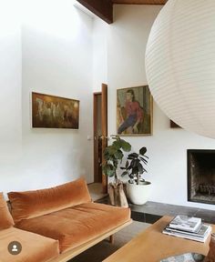 a living room filled with furniture and a fire place in front of a painting on the wall