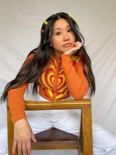 cropped orange cardigan with red, orange, and yellow heart design available in sizes xs, s, m, l model is 5'3" and wearing a size small Orange Cardigan, Yellow Heart, Orange And Yellow, Heart Design, Saree, Orange, Yellow, Red, How To Wear