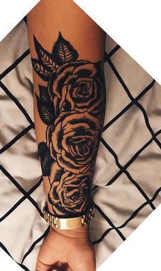 a woman's arm with black roses on it