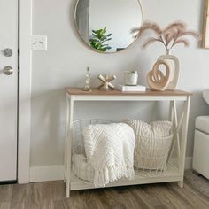 a white table with a mirror and some pillows