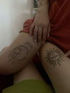 a woman's legs with sun and moon tattoos on the side of her thighs