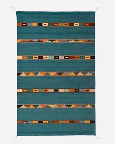 a blue rug with multicolored stripes on the front and back of it,