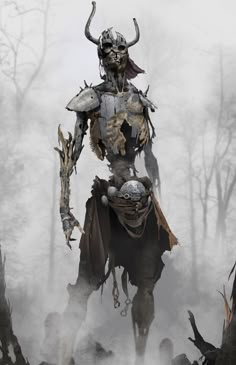 a man dressed as a demon standing in the middle of a forest filled with dead trees