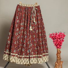 "Discover the enchanting allure of our Women's Hand Block Printed Long Skirt, meticulously crafted in the vibrant city of Jaipur, Rajasthan. This exquisite piece showcases the timeless artistry of hand block printing, a traditional technique that imparts a unique and captivating character to the garment. 100% cotton   Natural dyed   Hand block printed   Made by artist   Skirt flair 5 mtr   Skirt length 39\" Fashioned from premium-quality cotton, this maxi flared skirt not only provides comfort b Indian Pattern Skirt, Festive Bohemian Cotton Skirt, Bohemian Cotton Sharara For Diwali, Traditional Multicolor Maxi Skirt For Festivals, Red Cotton Long Skirt, Bohemian Cotton Sharara For Festive Occasions, Traditional Cotton Skirt For Festival, Traditional Cotton Sharara With Kalamkari Print, Traditional Cotton Tiered Skirt