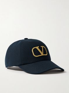 Valentino Garavani's baseball cap is embroidered with the iconic 'VLOGO' in gold threads - the first iteration debuted in 1968 and has become synonymous with the house ever since. Made from cotton-canvas, it has a sturdy brim and an adjustable tab to control the fit. Luxury Embroidered Logo Snapback Baseball Cap, Luxury Embroidered Snapback Baseball Cap, Designer Snapback Baseball Cap With Embroidered Logo, Luxury Snapback Baseball Cap With Embroidered Logo, Designer Baseball Cap With Embroidered Logo, Designer Embroidered Logo Baseball Cap, Luxury Hats With Logo Patch And Curved Brim, Luxury Baseball Cap With Curved Brim And Logo, Luxury Logo Baseball Cap With Curved Brim