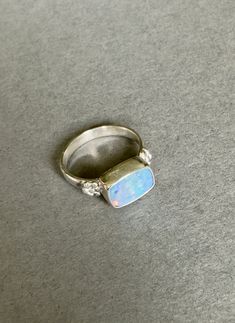 Pretty blue Opal doublet set in sterling silver and adorned with sterling silver flowers. Size is comfortable 8 1/2 US. Blue Opal Ring, Sterling Silver Flowers, Gift Ring, Opal Ring, Silver Flowers, Blue Opal, Ring Sterling Silver, Ring Handmade, Opal Rings