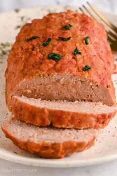 sliced meatloaf on a plate with a fork