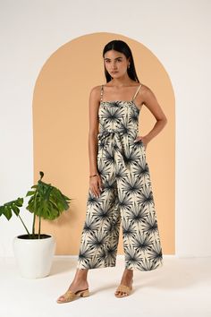 Exhibit your flair for style with this chic printed jumpsuit, a perfect blend of comfort and fashion. The jumpsuit features a tasteful Natural Palm colorway, a subtle yet captivating print that exudes a breezy, tropical vibe. One of the main highlights of this piece is the pintuck details that enhance its visual appeal, giving it a structured yet relaxed silhouette. Practicality is another strength of this jumpsuit, with handy pockets that not only add to its casual style but also provide space Printed Maxi Jumpsuits And Rompers For Summer, Chic Tropical Print Jumpsuits And Rompers For Spring, Casual Floral Print Maxi Jumpsuits And Rompers, Chic Printed Jumpsuit For Vacation, Chic Printed Jumpsuits And Rompers For Vacation, Chic Tropical Print Jumpsuits And Rompers For Vacation, Chic Tropical Print Jumpsuit For Vacation, Elegant Floral Print Jumpsuits And Rompers For Vacation, Chic Floral Print Maxi Jumpsuits And Rompers