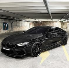 a black car parked in a parking garage