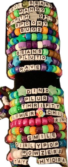 several bracelets are stacked on top of each other, with words written in different languages