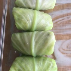 three pieces of cabbage sitting in a glass dish