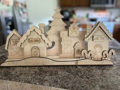 a wooden cutout of houses on a counter