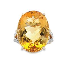 Adorn your finger with opulent elegance with this 14 karat yellow gold ring featuring a breathtaking citrine gemstone weighing an impressive 18.39 carats. The vibrant citrine commands attention with its warm golden hues, radiating beauty and sophistication. Embellishing the sides of the ring are 1/4 carat in total of dazzling diamonds, adding a touch of sparkle and glamour to the piece. This stunning ring is a true statement of luxury and style, perfect for adding a bold accent to any ensemble. Luxury Yellow Gold Citrine Diamond Ring, Luxury Citrine Diamond Ring In Yellow Gold, Luxury Yellow Topaz Ring With Diamond Accents, Formal Yellow Topaz Ring With Diamond Accents, Luxury Yellow Gold Topaz Ring With Gemstone Accents, Luxury Citrine Topaz Ring With Gemstone Accents, Elegant Yellow Topaz Ring With Brilliant Cut, Elegant Orange Rings With Gemstone Accents, Luxury Citrine Topaz Ring With Accent Stones