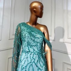 Mesmerizing Turquoise Hue: Radiates vibrance and charm, perfect for making a statement. Mermaid Silhouette: Accentuates curves gracefully, offering a flattering fit. Overskirt Detail: Adds drama and flair to the gown, creating an eye-catching look. Luxurious Beaded Embellishments: Enhances the gown's elegance and adds a touch of sparkle. High-Quality Craftsmanship: Expertly crafted for comfort, durability, and a flawless finish. Versatile Wear: Suitable for various occasions, including weddings, Beaded Embellishments, Formal Parties, Water Blue, Mermaid Silhouette, Ladies Party, Evening Gowns, Gowns Dresses, Evening Dresses, Embellishments