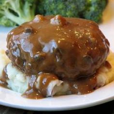 a close up of a plate of food with mashed potatoes and gravy