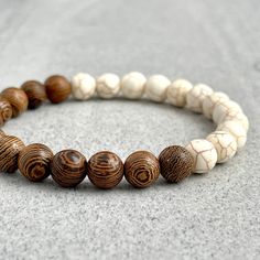 Features ~ 6mm, 8mm or 10mm Matte Magnesite beads ~ 6mm, 8mm or 10mm Wenge Wood beads ~ Stretchy cord; simply slide bracelet on and off wrist ~ Comes packaged in a re-usable microfiber pouch To ensure the perfect fit, please use the bracelet sizing instructions found in the photo gallery. Magnesite -  Magnesite can help you need feel calm, especially when over-worked, over-stressed and trying to keep up with the demands of family. It opens up the Crown and Third Eye chakras to enhance deep relax Wooden Beaded Bracelets, Jasper Bead Bracelet, Wenge Wood, Slide Bracelet, Wood Bead Bracelet, Wooden Bracelet, Wood Bracelet, Beads Bracelet Design, Les Chakras