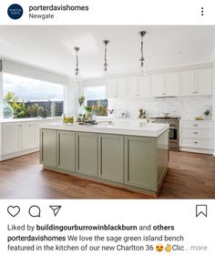 a large kitchen with an island in the middle and lots of cabinets on both sides