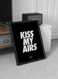 a sign that says kiss my airs on it next to a guitar and amps