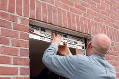 a man is measuring the width of a window