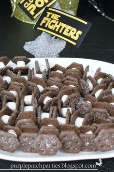 a plate full of chocolate pretzels and marshmallows