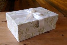 a white box with a ribbon tied around it