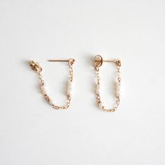 Dainty pearl chain hoop stud earrings. They are so simple and minimal that they would go with any outfit! Every piece is handcrafted in NYC, and pearls are natural, so shapes and colors may be slightly different from each other. These earrings will be made for you after the order is placed. The item will either be packaged in a jewelry pouch or in a jewelry gift box. Perfect as a gift! MATERIALS 14k gold filled Freshwater pearls DIMENSIONS approx. 1/2" (13mm) width x 1" (25mm) length Stud Hoop Earrings, Rings Packaging Ideas, Everyday 14k Gold Filled Pearl Chain Earrings, Minimalist Pearl Chain 14k Gold Filled Earrings, Minimalist Pearl Chain Earrings In 14k Gold Filled, Minimalist 14k Gold Filled Pearl Chain Earrings, Minimalist Pearl Earrings With Adjustable Chain, Dainty Pearl Earrings With Adjustable Chain, Handmade Minimalist Pearl Earrings