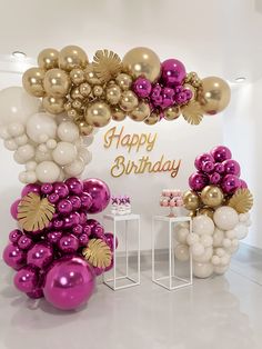 an arch made out of balloons with the words happy birthday written on it in gold and purple