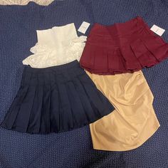 All Four Skirts Are New With Tags , Navy Is Pleated Also Burgundy But A Different Style Of Pleat , Beige Has Rouching On Side And White Is Flouncy With Elastic On Top And Lace On Bottom , Comes From A Pet And Smoke Free Home Summer School Uniform Style Mini Skirt, Summer School Uniform Style Lined Skirt, High-waist School Uniform Bottoms For Summer, Spring School Uniform Mini Skirt, High Waist School Uniform Bottoms For Summer, Chic Summer School Skirt, High Waist Skirt For Summer School Uniform, Chic Mini Skirt For School, School Uniform Style Lined Mini Skirt