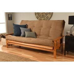 a living room with a futon and wooden floors