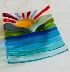 a colorful glass dish sitting on top of a counter